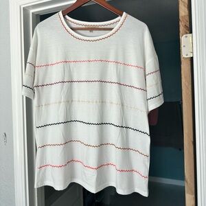 White top with striped embroidered like details